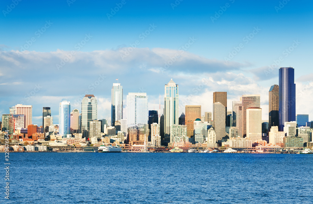 Day panorama of Seattle busy downtown skyline over Elliot bay waters, Washington, USA