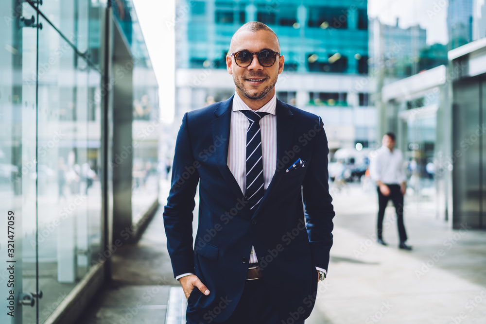 Stylish businessman in elegant suit looking at camera Stylish businessman in elegant suit looking at camera