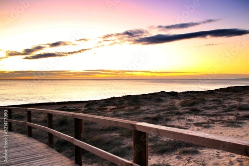Wooden walkway to the beach at sunrise in Alicante  Spain