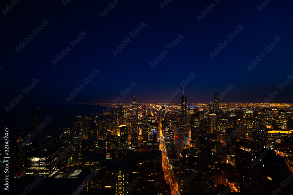 Night panorama skyline view of streets and tall skyscrapers of Chicago from above