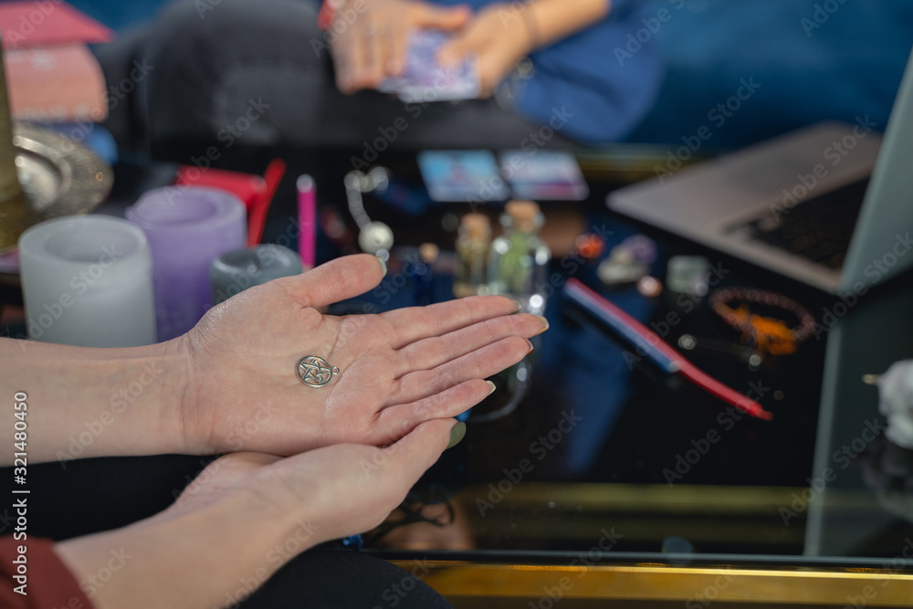 Caucasian woman sitting at a fortune-tellers session