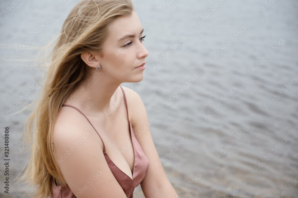 Young woman in pink dress on sand and enjoys sea. Young woman in pink dress on sand and enjoys sea.