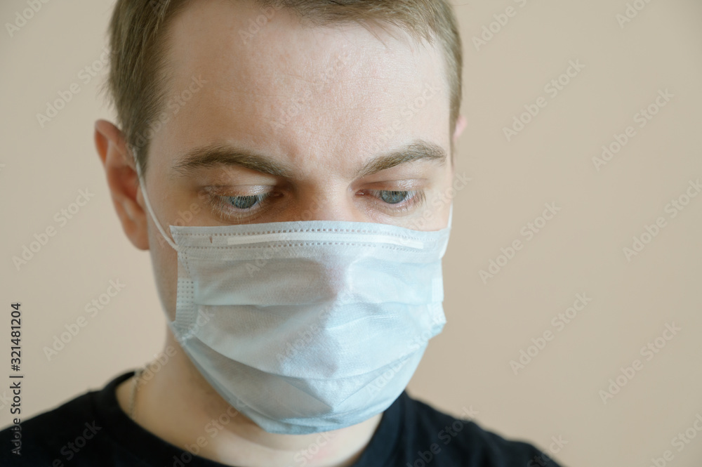 Young man wearing protective medical mask. Selective focus. Young man wearing protective medical mask. Selective focus.