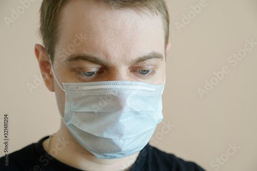 Young man wearing protective medical mask. Selective focus.