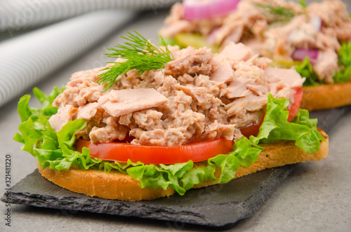 Wallpaper Mural Tuna sandwiches with lettuce tomatoes pickles and onions on slate tray Torontodigital.ca