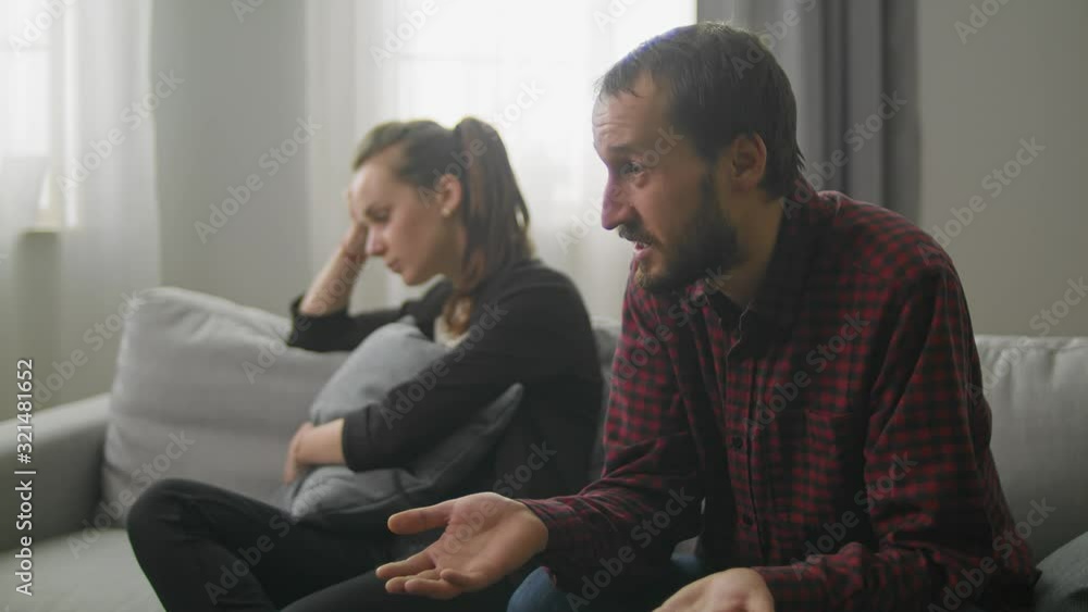 Young couple in the office of a family psychoanalyst. Oral Quarrel Young couple in the office of a family psychoanalyst. Oral Quarrel