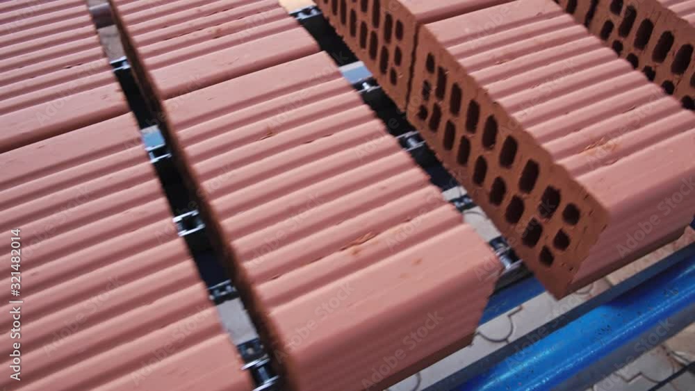 Grey bricks are moving on a manufacturing line on the fully automated factory Grey bricks are moving on a manufacturing line on the fully automated factory
