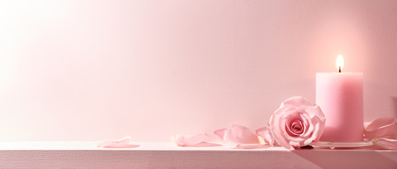Pink Roses and candle on a pink background