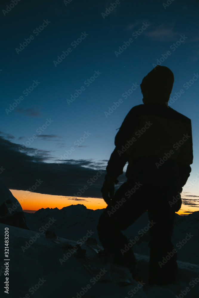 silhouette of man on sunset background of the sky