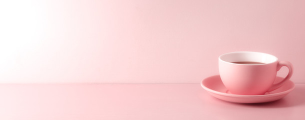 A cup of fresh coffee on pink background