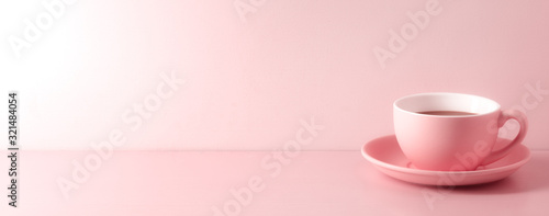 A cup of fresh coffee on pink background