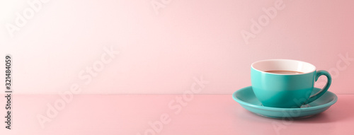 A cup of fresh coffee on pink background