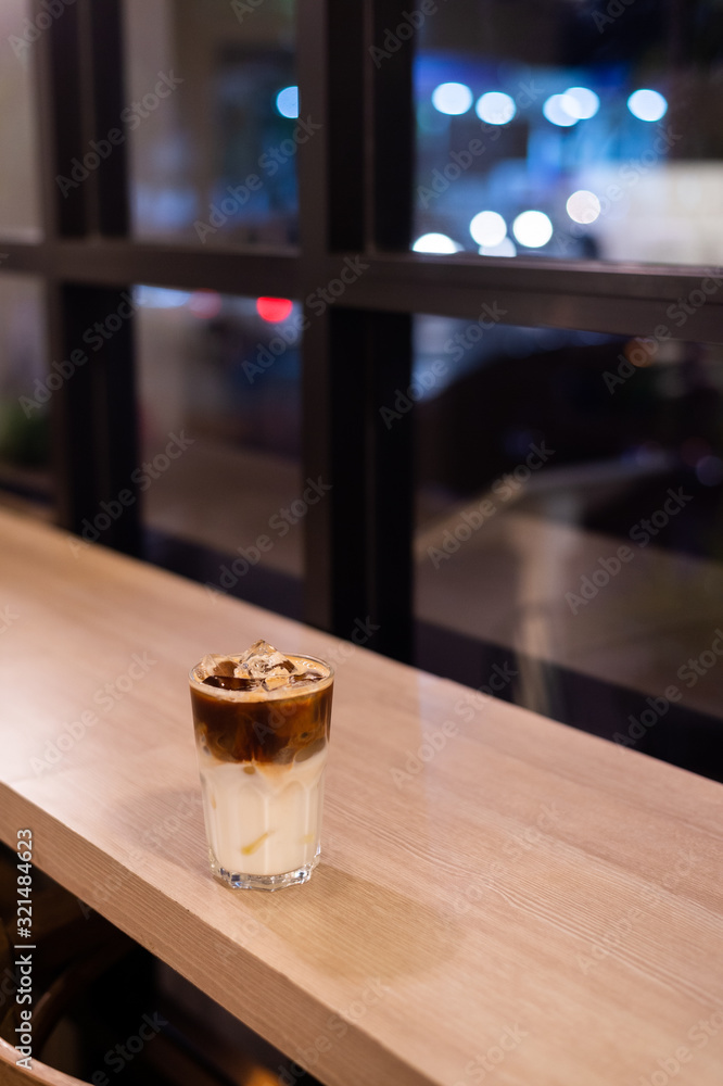 iced coffee put on wooden table in mini cafe