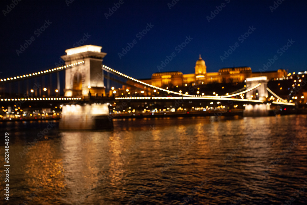 Blurred chain bridge in Budapest at night. Hungarian landmarks Blurred chain bridge in Budapest at night. Hungarian landmarks