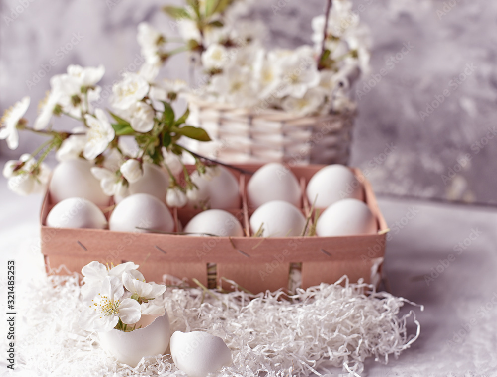 Easter still life. Gentle light photo. White eggs and delicate spring flowers of cherry and peach. Easter still life. Gentle light photo. White eggs and delicate spring flowers of cherry and peach.
