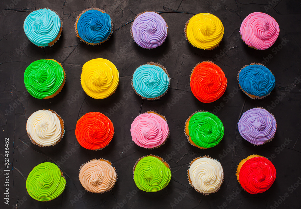 Many delicious sweet cupcakes of different colors Many delicious sweet cupcakes of different colors