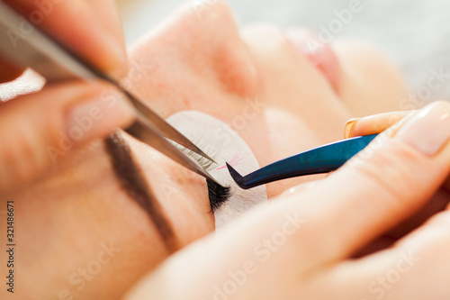 Beautician making artificial lashes. Eyelash extension procedure