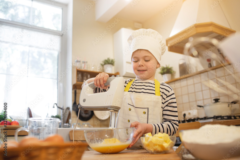 Little boy in chef's hat are cooking Little boy in chef's hat are cooking