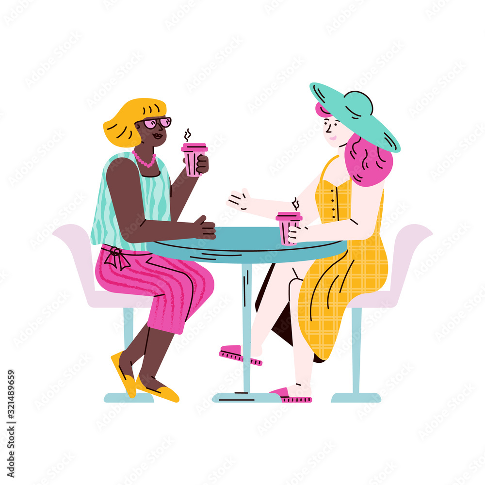 Two female friends sitting at table drinking take out coffee and talking Two female friends sitting at table drinking take out coffee and talking