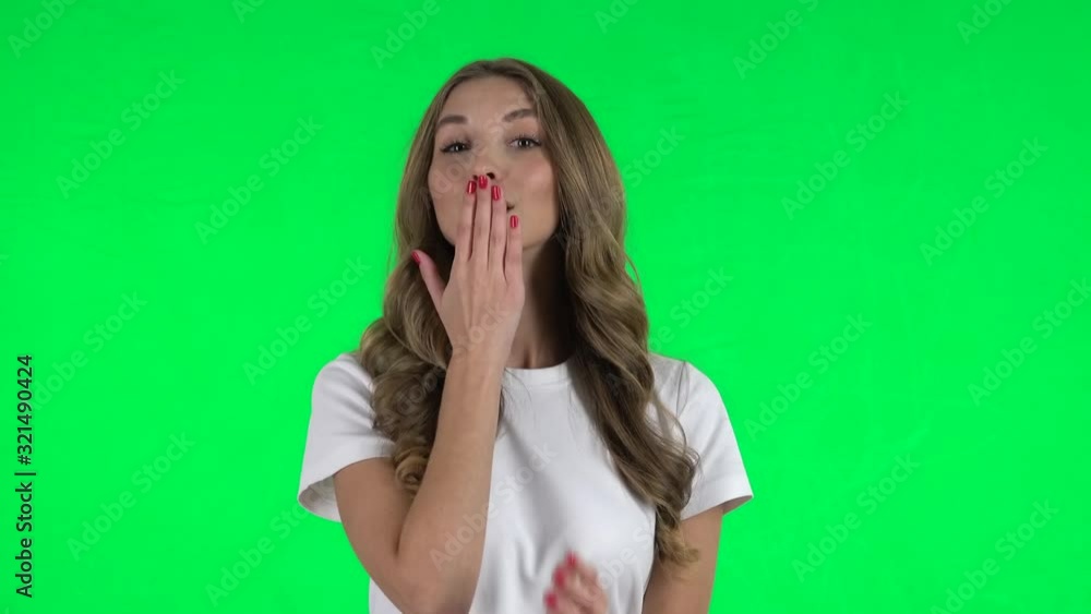 Lovable girl smiling and showing heart with fingers then blowing kiss. Green screen Lovable girl smiling and showing heart with fingers then blowing kiss. Green screen
