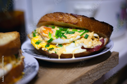 roasted sandwich with sausage, egg, cheese and green onions. juicy double toast bread sandwich