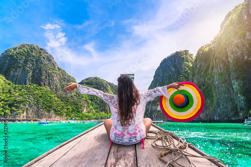 Obraz na płótnie Happy traveler woman in beach wear joy fun on boat, Maya bay Phi Phi island Krab