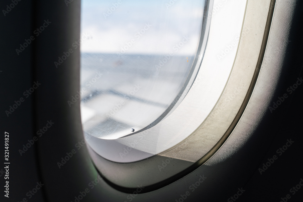 Sunlight coming in through window in airplane