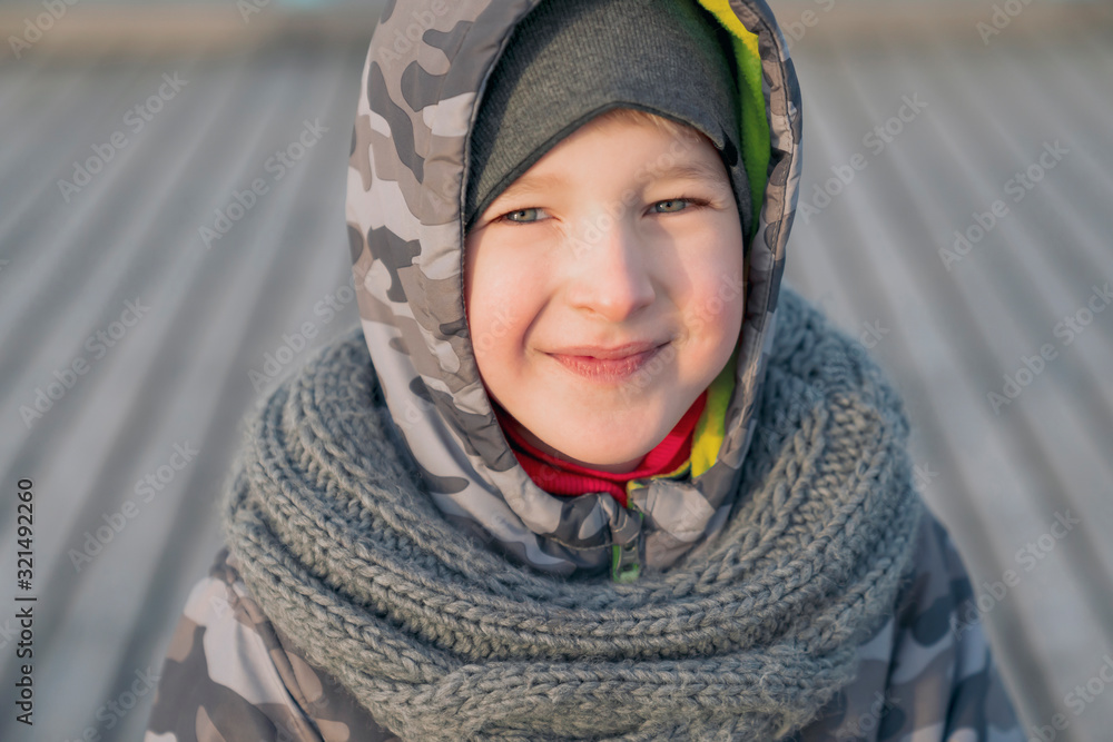 A sincere smile of child. Seven years old boy in good mood, positive emotions. Cold season day. A sincere smile of child. Seven years old boy in good mood, positive emotions. Cold season day.