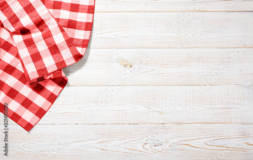 Napkin. Kitchen towel or table cloth on white wooden scene. Mock up for design. Top view.