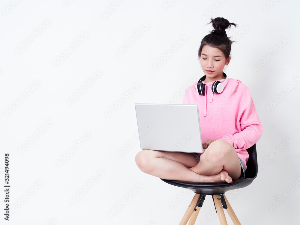 Cheerful girl using laptop sitting on chair. Cheerful girl using laptop sitting on chair.