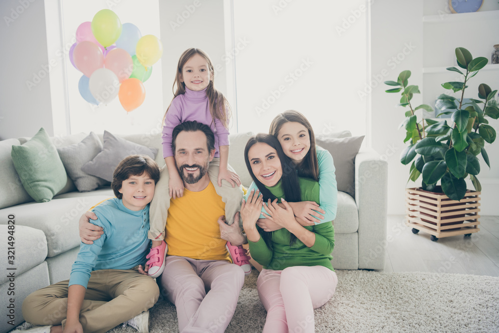 Dream cozy loving family people sit floor carpet mom mommy hug cuddle her small preteen girl dad daddy piggyback younger adopted kid celebrate anniversary day in house living room