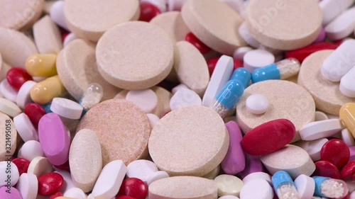 Variety of pills and tablets medicine on rotation stand
