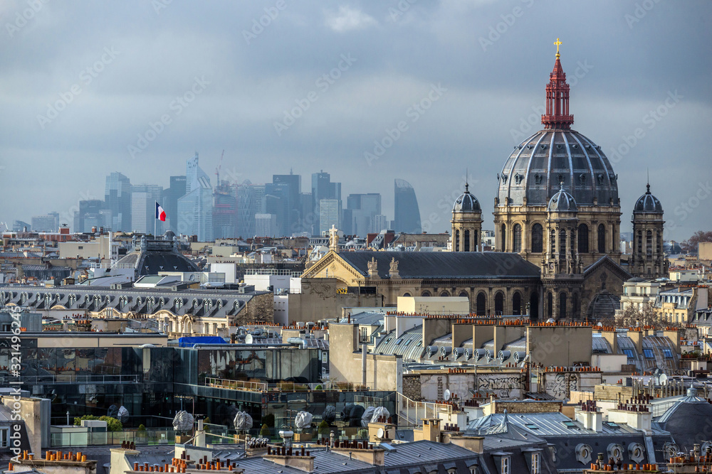 FEBRUARY 1, 2019 - PARIS, FRANCE: Skyline of Paris rooftops, Saint Augustin church and La Defense district