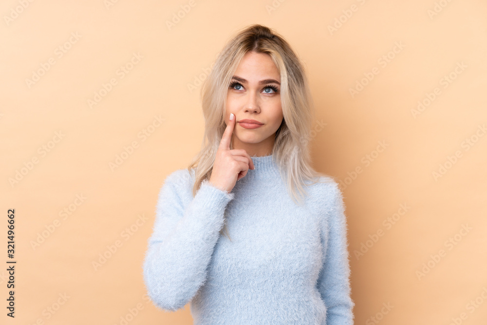 Teenager girl over isolated background thinking an idea Teenager girl over isolated background thinking an idea