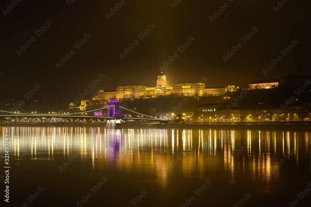Budapest Chain Bridge (Széchenyi Chain Bridge), Buda Castle and the Danube River at night. Night Cityscape with lights in Budapest, Hungary.
