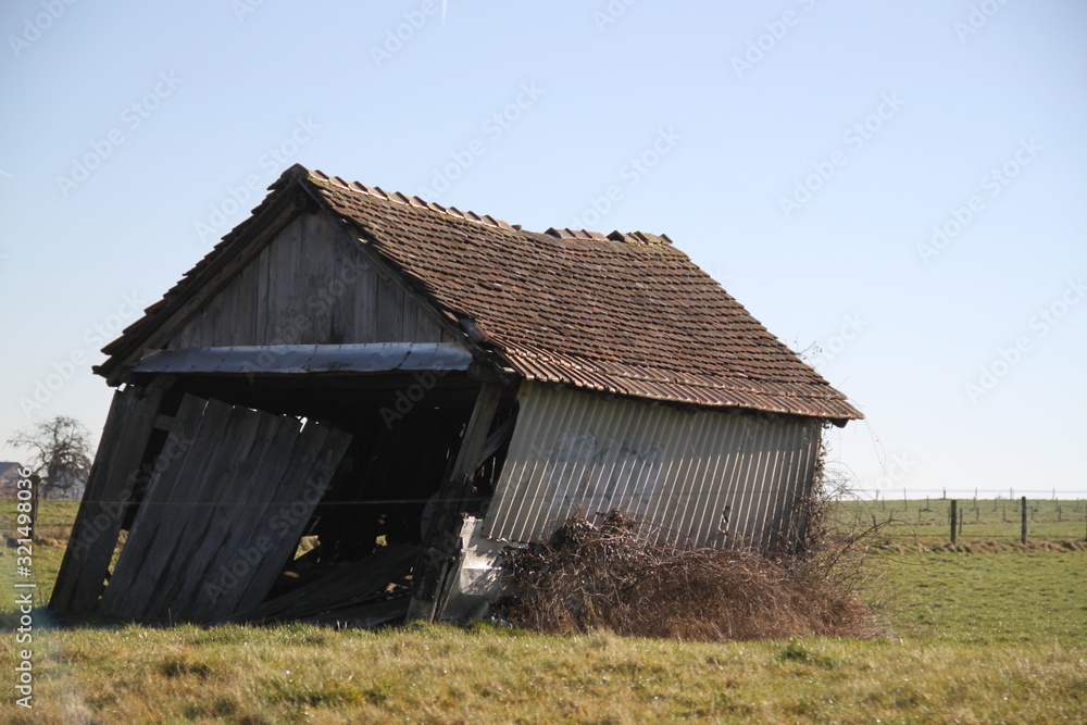 Wood destroyed hut leaning in the meadow Wood destroyed hut leaning in the meadow