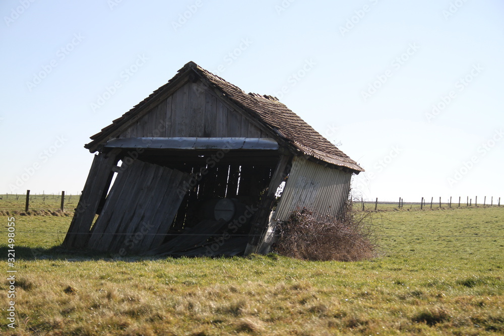 Wood destroyed hut leaning in the meadow Wood destroyed hut leaning in the meadow