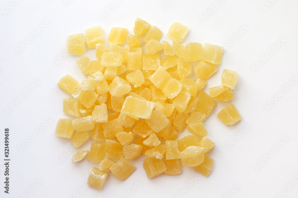 Dried pineapple cubes on a white background. Candied pineapple top view. Sweet dried pineapples in sugar syrup. Dried pineapple cubes on a white background. Candied pineapple top view. Sweet dried pineapples in sugar syrup.