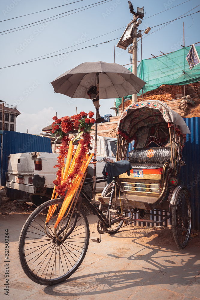 Fototapeta premium Colorful traditional rickshaws parked in the streets of Thamel district in Kathmandu city, Nepal
