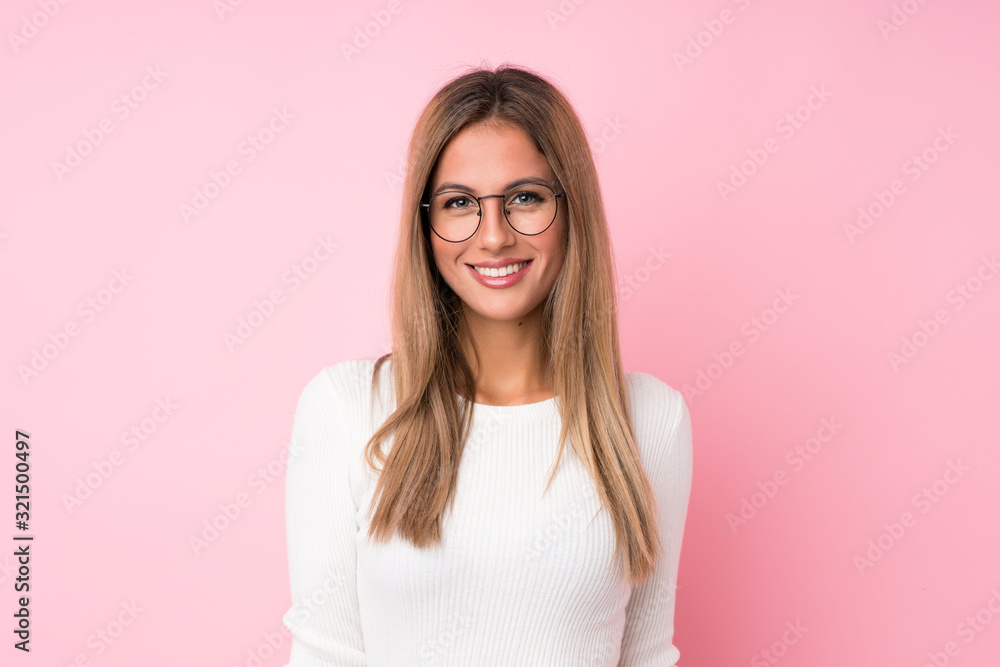 Young blonde woman over isolated pink background with glasses - obrazy, fototapety, plakaty 
