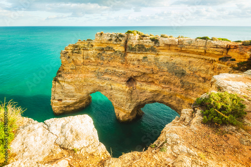 Natural arches underneath rugged cliffs, Praia da Marinha, Algarve, Portugal, Europe © Mikael