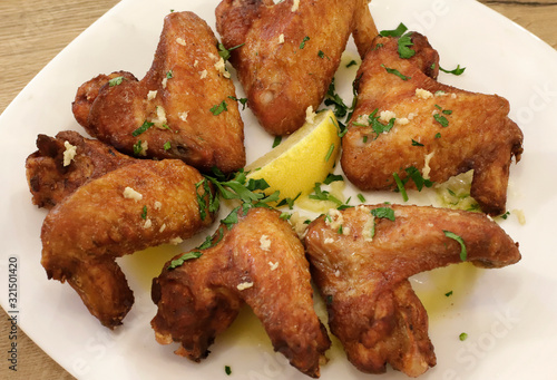 Fried Spicy chicken wings with lemon. View from above.