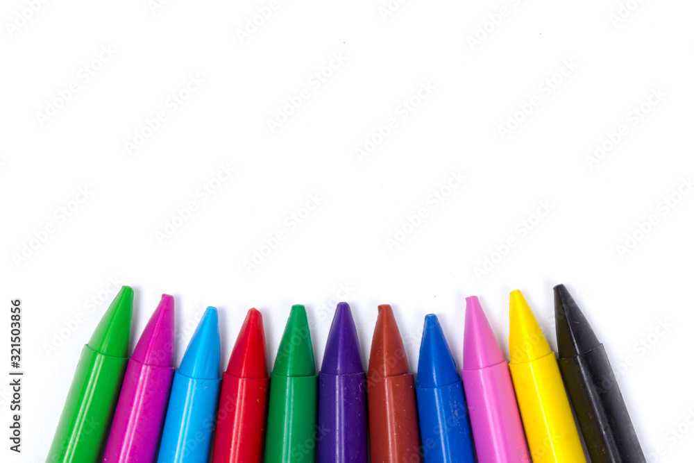 Colored wax pencils. A bunch on white background close-up Colored wax pencils. A bunch on white background close-up