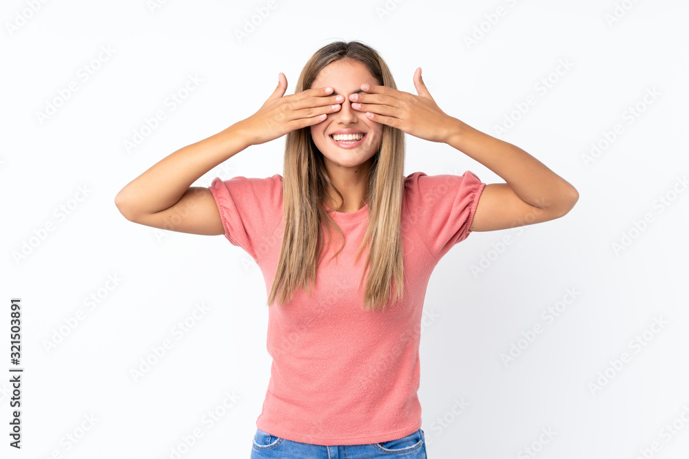 Young blonde woman over isolated white background covering eyes by hands Young blonde woman over isolated white background covering eyes by hands
