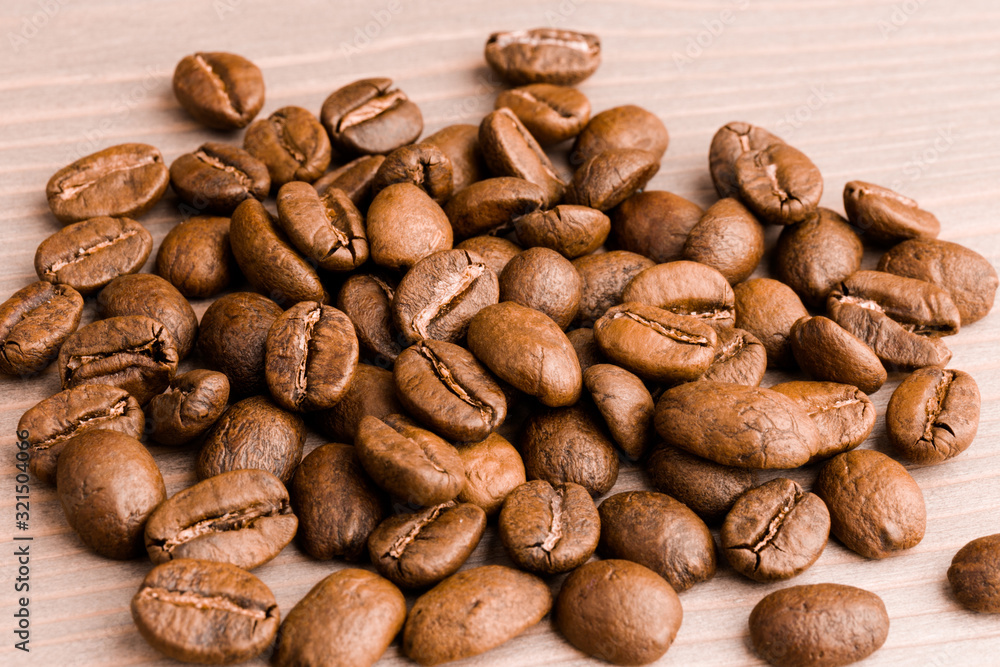 coffee beans. the pile on wooden table. close up coffee beans. the pile on wooden table. close up