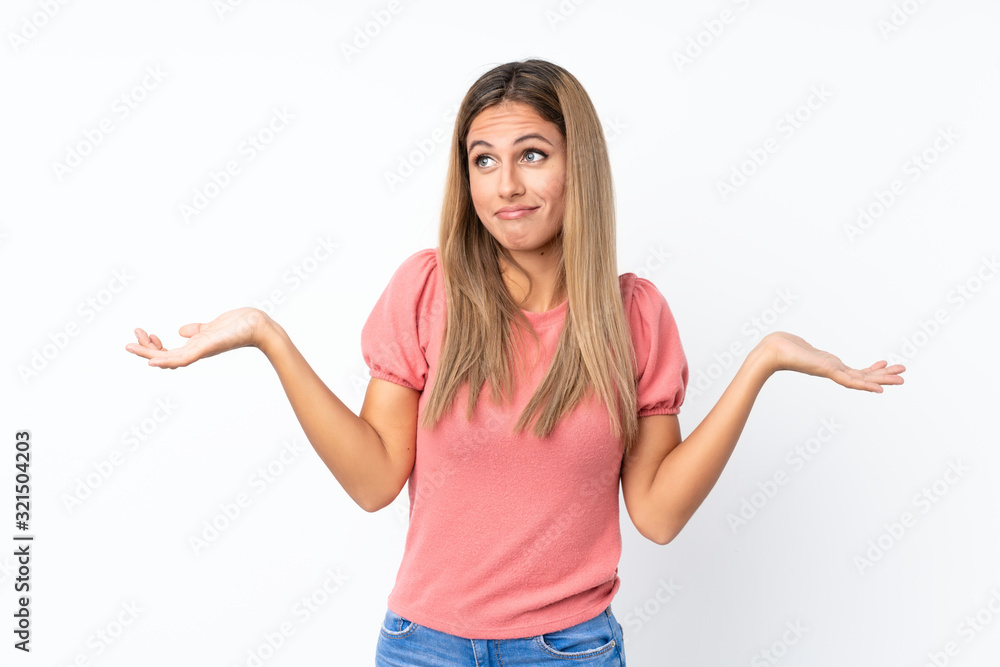 Young blonde woman over isolated white background making doubts gesture Young blonde woman over isolated white background making doubts gesture