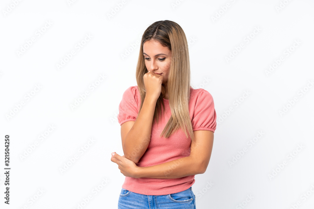 Young blonde woman over isolated white background having doubts Young blonde woman over isolated white background having doubts