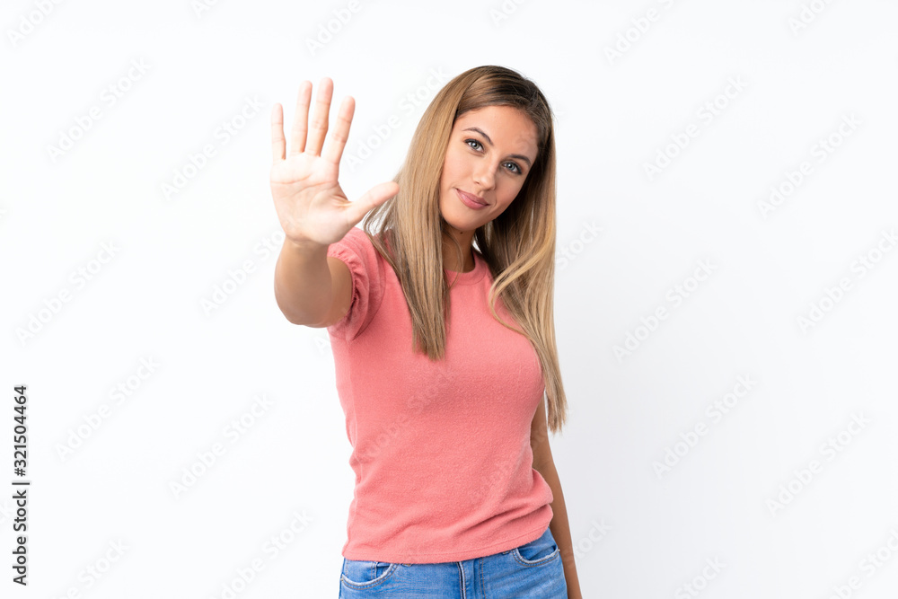 Fototapeta premium Young blonde woman over isolated white background counting five with fingers