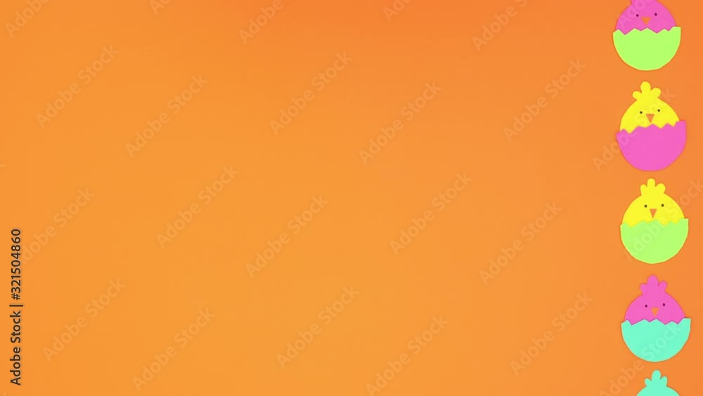Easter chicken in eggs rolling on right side of orange background - Stop motion Easter chicken in eggs rolling on right side of orange background - Stop motion