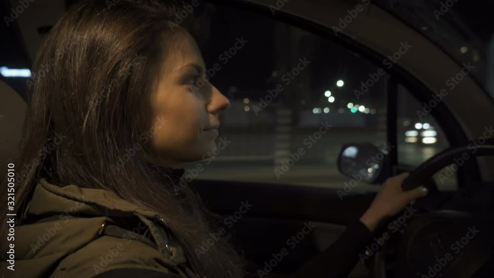 Female driver driving a car at night Female driver driving a car at night